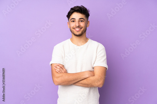 Arabian handsome man over isolated background keeping the arms crossed in frontal position photo