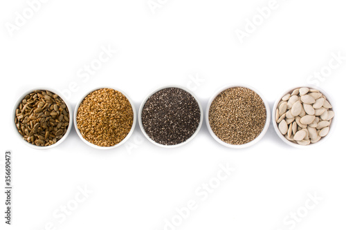 Assortment of different seeds in bowl isolated on white background. Pumpkin, linen, chia, sunflower, and sesame seeds. Top view