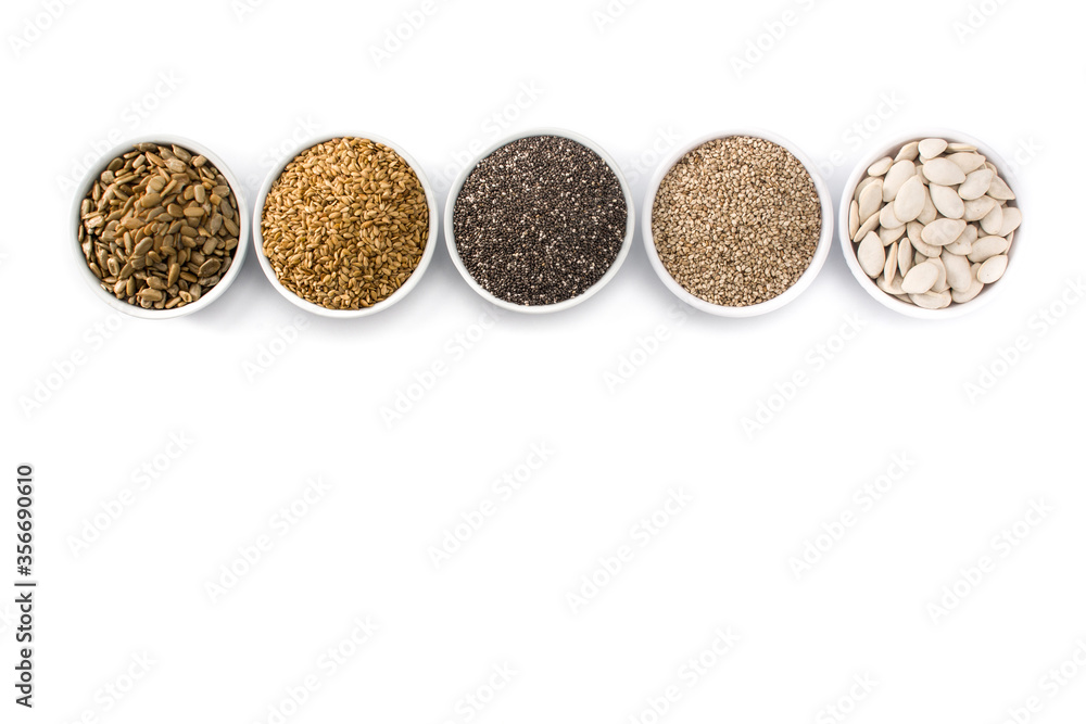 Assortment of different seeds in bowl isolated on white background. Pumpkin, linen, chia, sunflower, and sesame seeds Assortment of different seeds in bowl isolated on white background. Pumpkin, linen, chia, sunflower, and sesame seeds