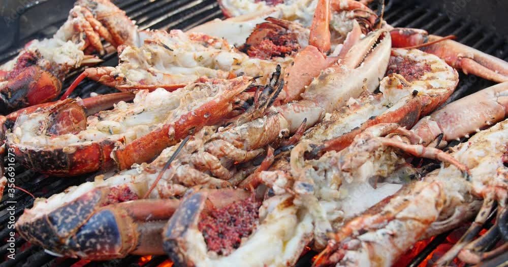 Giant grilled lobster cook on charcoal stove. blue lobster dinner at