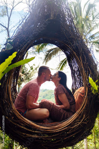A tourist couple sitting on...
