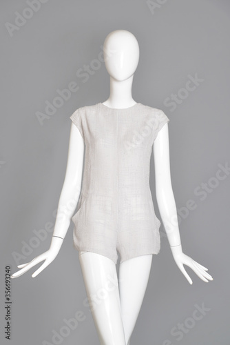 lifeless mannequin with blue beach dress isolated grey background studio