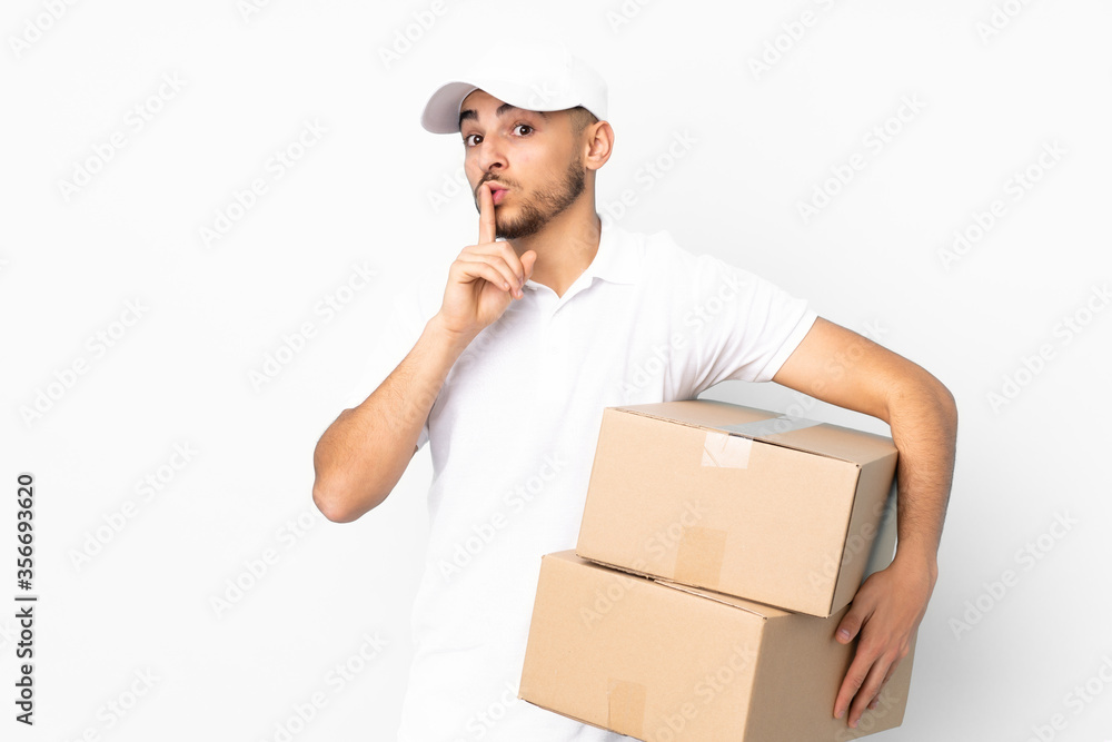 Delivery Arabian man isolated on blue background doing silence gesture Delivery Arabian man isolated on blue background doing silence gesture
