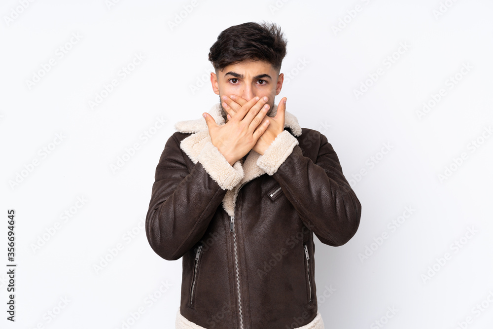 Arabian handsome man over isolated background covering mouth with hands Arabian handsome man over isolated background covering mouth with hands