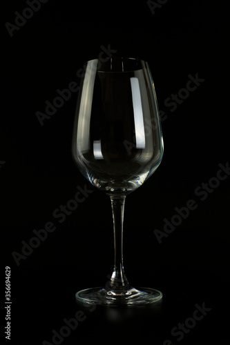 Empty wine glass on black background.