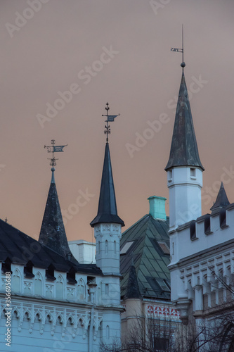 View to the roofs and towers of the Small Guild and the Great Guild in the Old Town of Riga under dramatic evening clouds