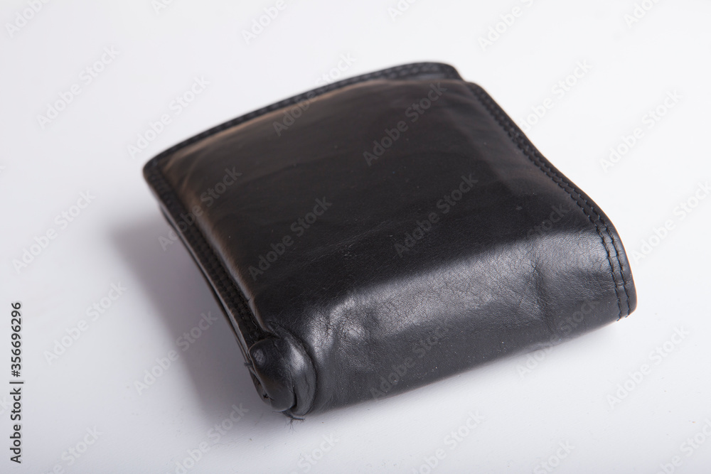 a close up isolated shot of a black leather business wallet with reflection of light on its side on a white background with soft shadows a close up isolated shot of a black leather business wallet with reflection of light on its side on a white background with soft shadows