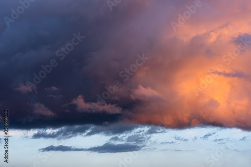 Colorful dramatic sunset, bright unusual clouds in the sky.