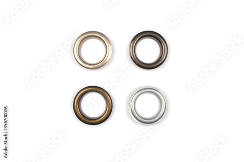 Tableau sur toile Four brass multicoloured metal eyelets or rivets - curtains rings for fastening fabric to the cornice, isolated on white
