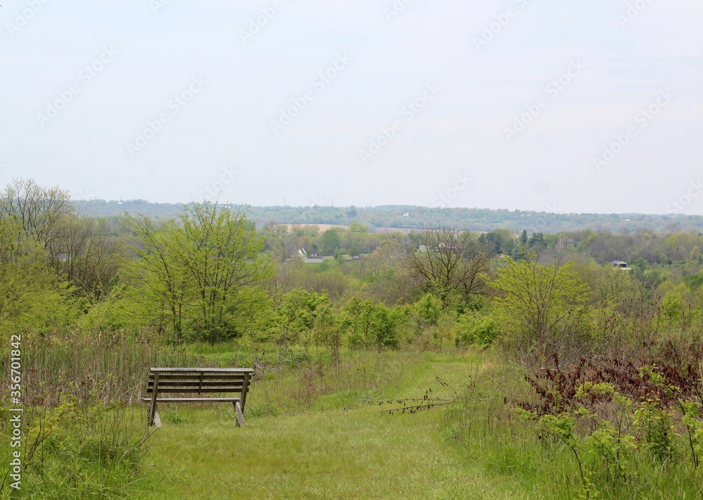 The empty bench and the countryside on a hot humid day. The empty bench and the countryside on a hot humid day.