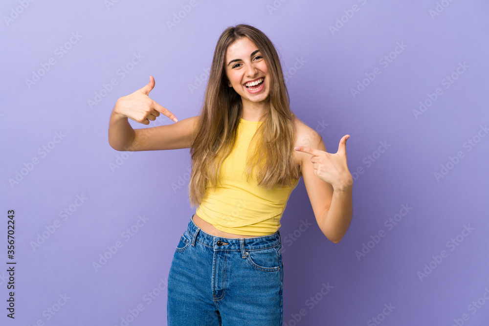 Young woman over isolated purple background proud and self-satisfied Young woman over isolated purple background proud and self-satisfied