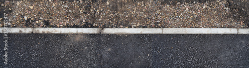 Edge of paved pavement with dividing curb.