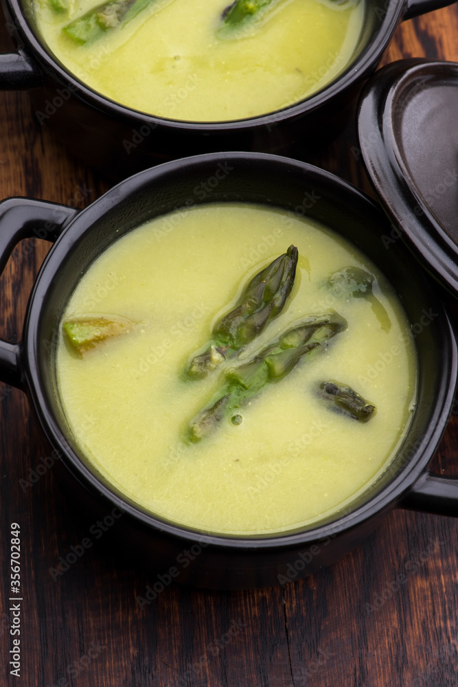 Green spring pureed asparagus soup served in plates Green spring pureed asparagus soup served in plates