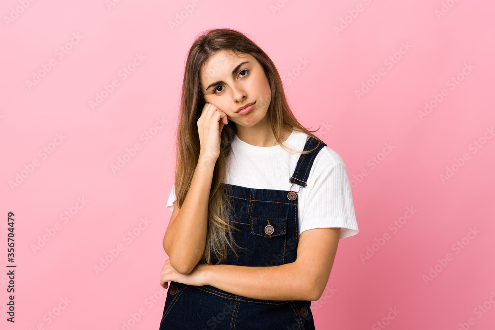 Young woman over isolated pink background with tired and bored expression Young woman over isolated pink background with tired and bored expression