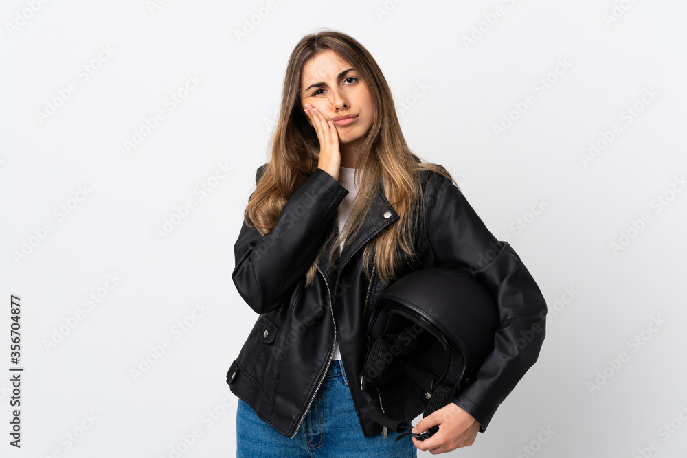 Young Woman holding a motorcycle helmet over isolated white background unhappy and frustrated Young Woman holding a motorcycle helmet over isolated white background unhappy and frustrated