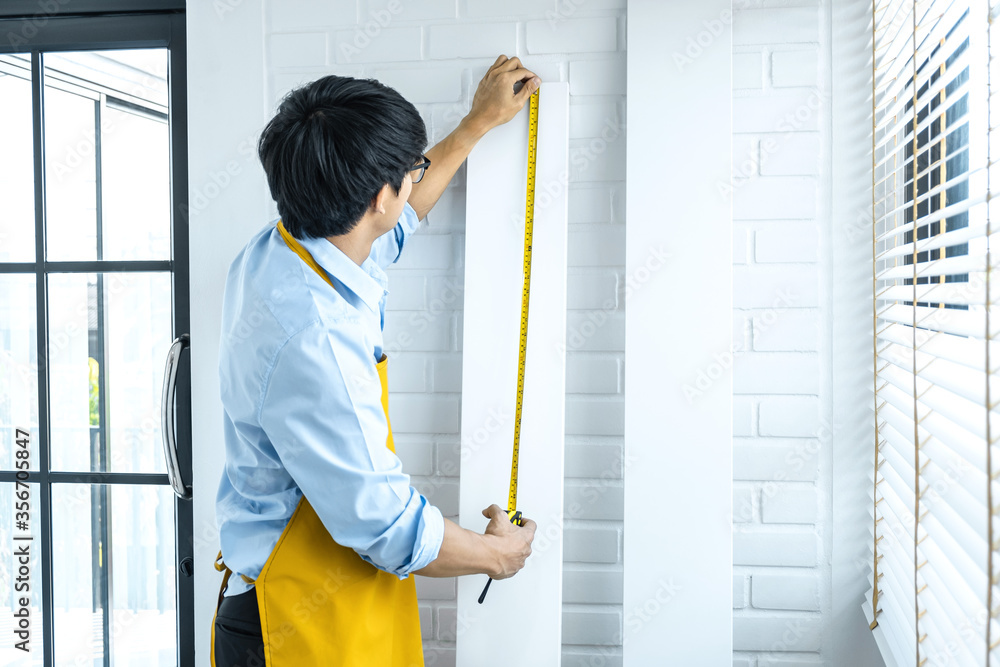 Craftsman doing renovation work at home improvement with measure wooden floor and interior design concept Craftsman doing renovation work at home improvement with measure wooden floor and interior design concept