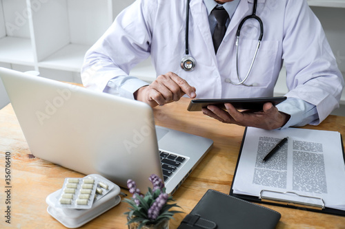 Health care and Medical concept  doctor checking patient history form while think about finding a cure for a diagnosis  treatment methods to rehabilitate the body recommend treat of patient