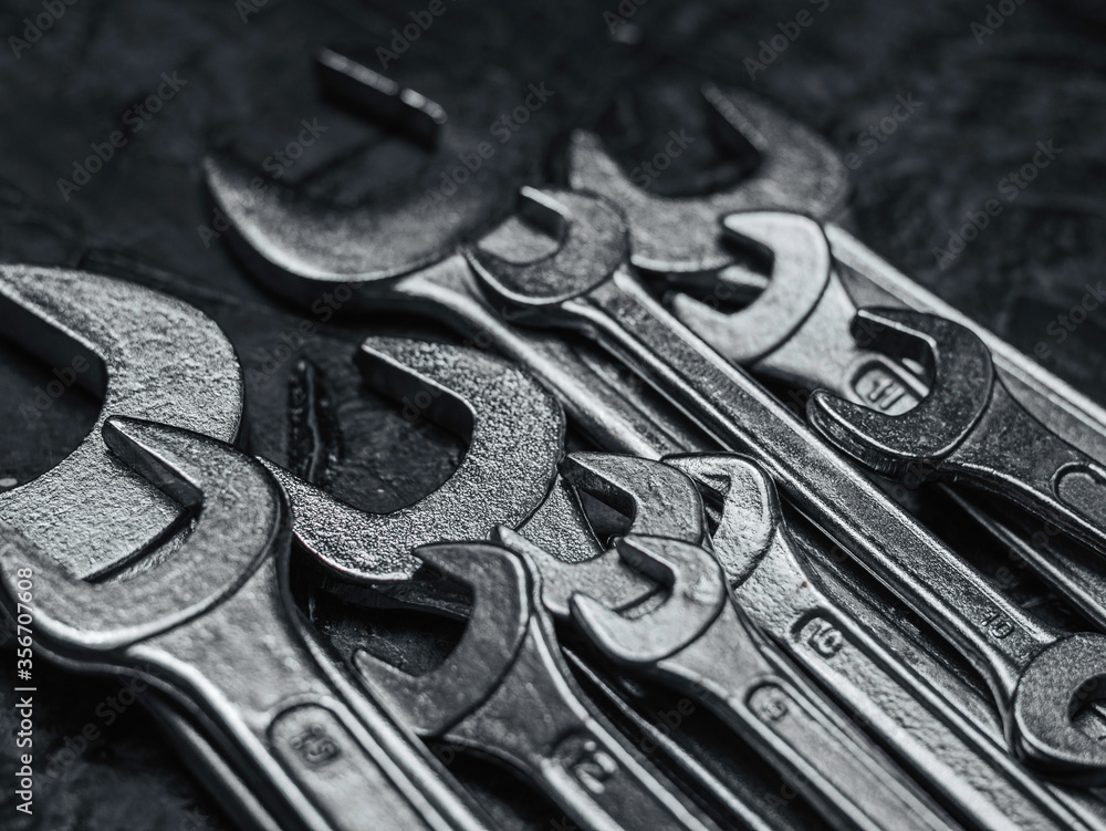 Fototapeta premium Wrenches, tools on grey stone table. Worker tools and equipments close-up.