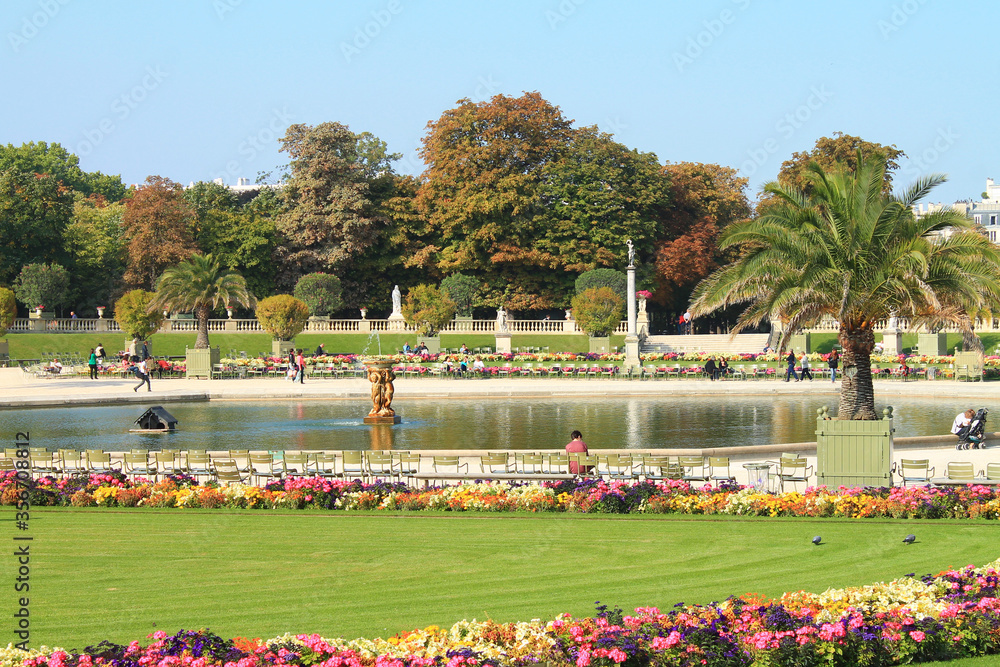 PARIS, FRANCE - SEPTEMBER 10, 2018: View of Luxembourg park in Paris with blooming flowers and tourists.