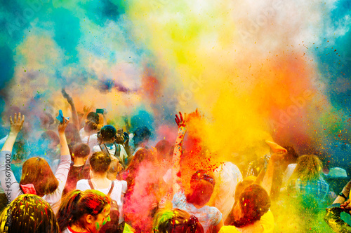 Holi color festival. Celebrating dances. Throwing colored powder. Spring Festival. photo