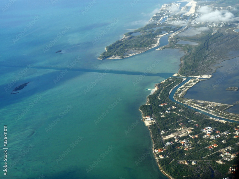 Close aerial view of the coastline of Nassau, Bahamas seen from an airplane window.