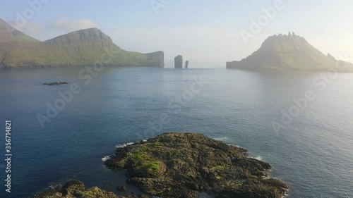 4k drone forward video (Ultra High Definition) of Tindholmur cliffs. Splendid morning view of Vagar island, Denmark, Faroe Islands, Europe. Traveling concept background. photo