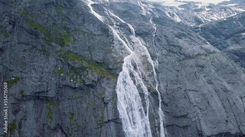 Waterfall of melting glacier at Briksdalsbreen glacier in the national park of Jostedalsbreen in nature of Norway