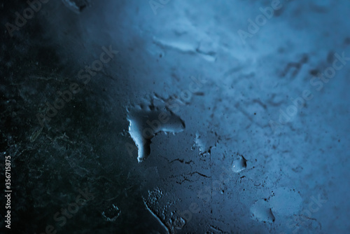 Macro photography of a window blurred and wet by raindrops, perfect combination for nostalgia