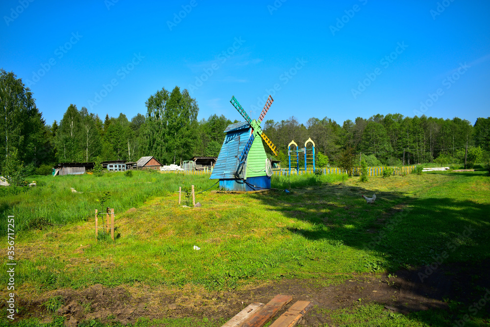 Fototapeta premium imitation of a village mill in the grass