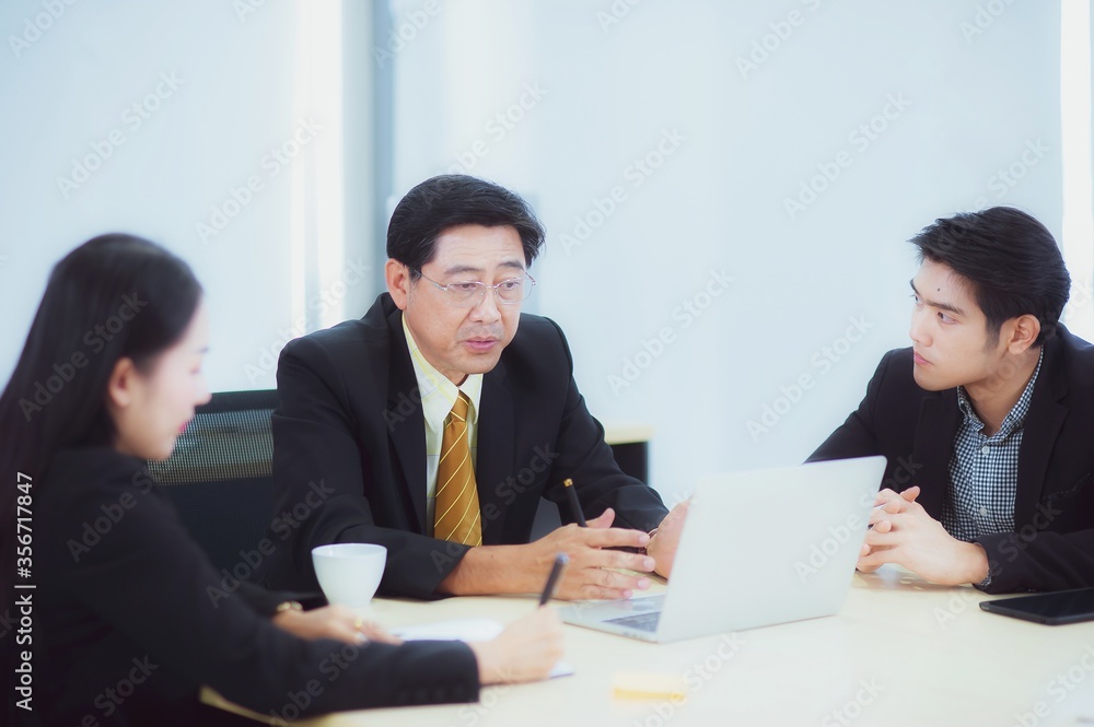 Asian corporate business team is meeting and manager is explain the work and assign the work to the team members. Asian corporate business team is meeting and manager is explain the work and assign the work to the team members.