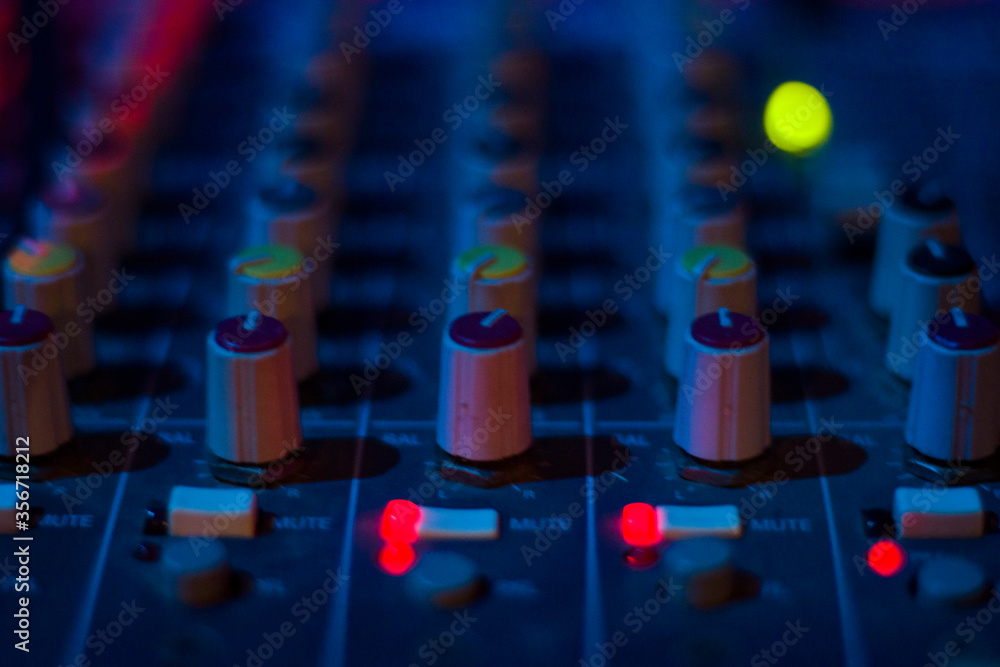 Fototapeta premium DJ controller and color Light Music Instrument Backgrounds. Audio mixer ..