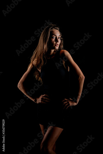 Very Pretty model in the studio slim and well built nice hair black dress © Kirk Voclain
