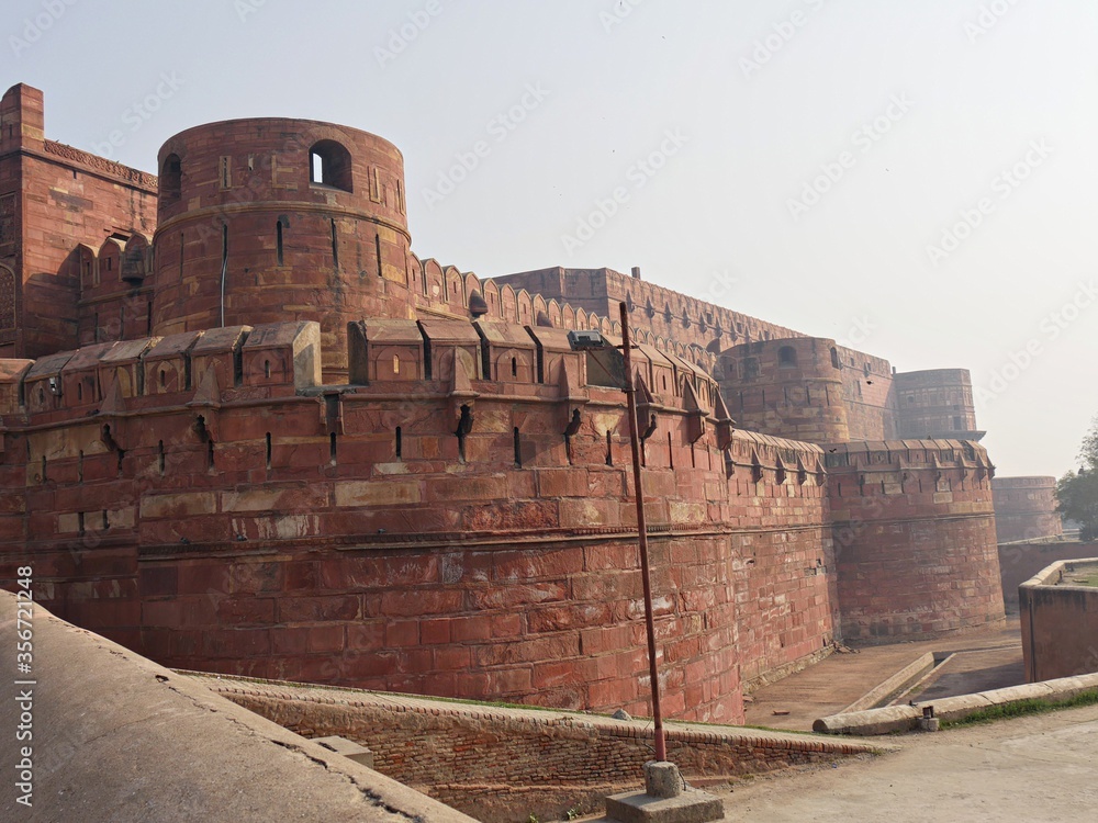  Side view of the massive red brick walls of the Agra Fort, a UNESCO World Heritage site in India.