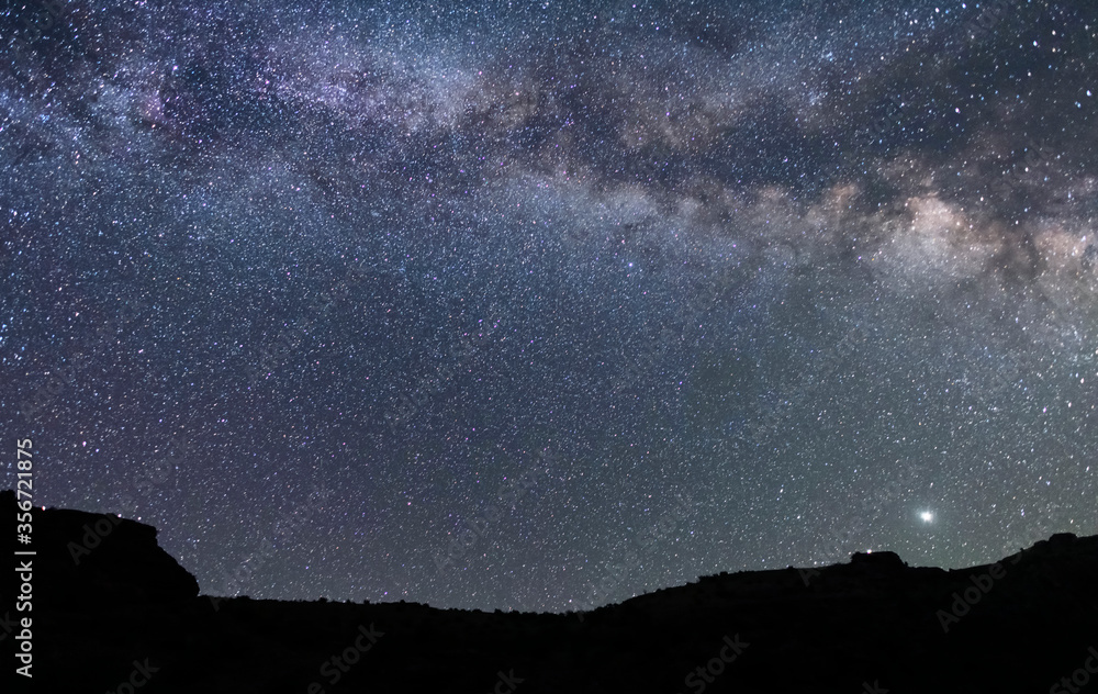 Beautiful starry sky with bright milky way galaxy. Night landscape. Astronomical background.