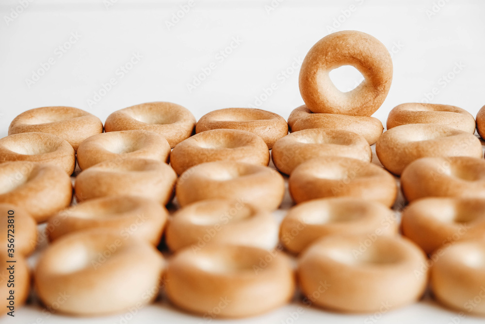 Drying or mini round bagels on a white wooden background. Top view. Copy, empty space for text Drying or mini round bagels on a white wooden background. Top view. Copy, empty space for text