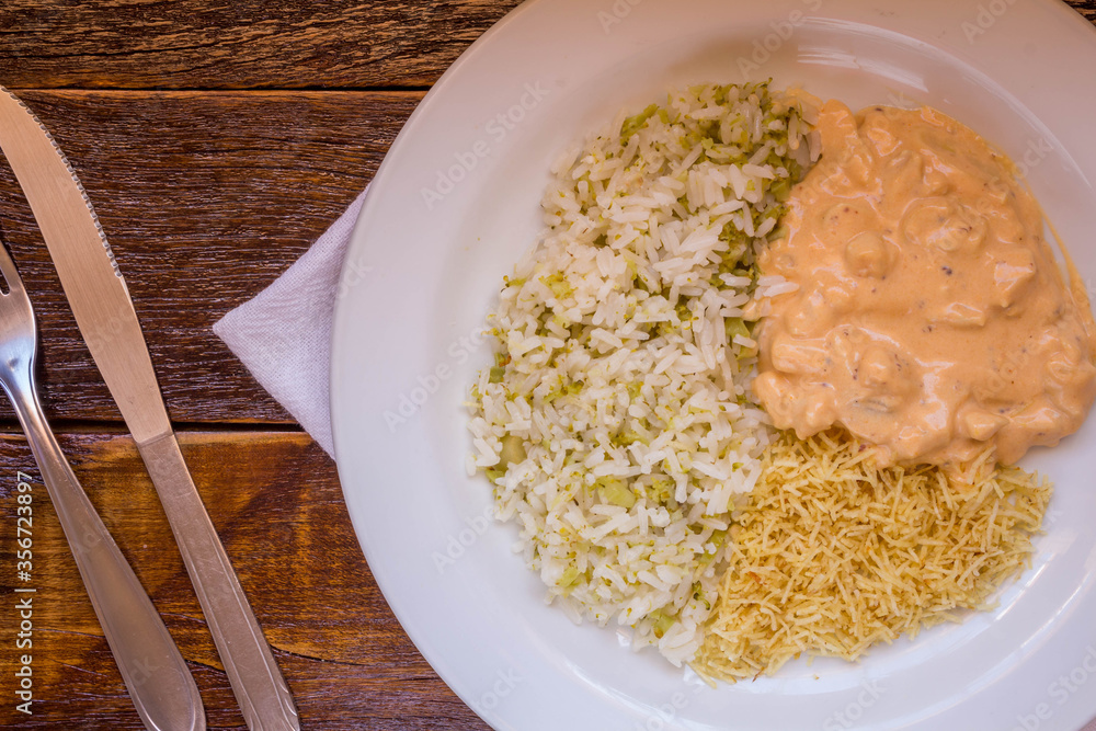Delicious healthy food with chicken strogonoff with rice and french fries on dish. View from the top Delicious healthy food with chicken strogonoff with rice and french fries on dish. View from the top