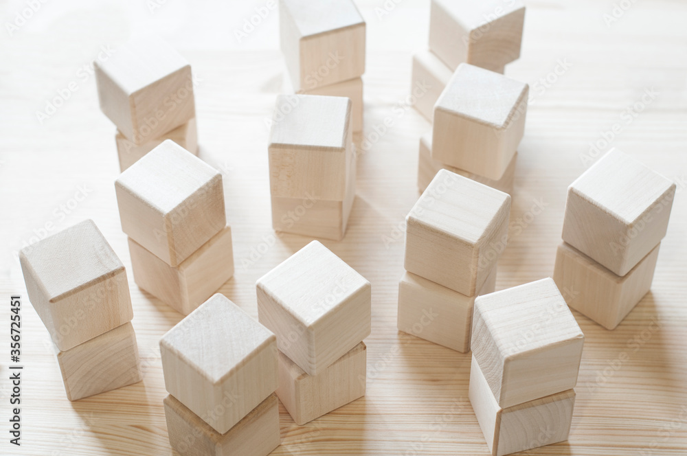 Wooden cubes. 3D geometric shapes. On wooden background