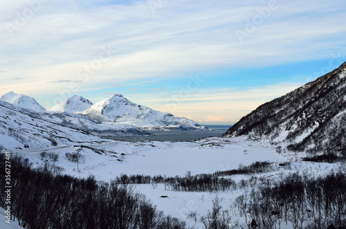 snowy mountain with sunshine blue sky and fjord landscape