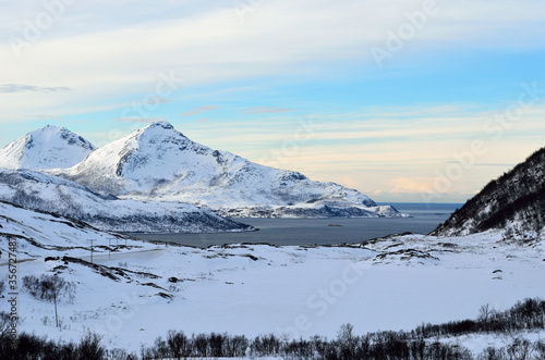 snowy mountain with sunshine blue sky and fjord landscape