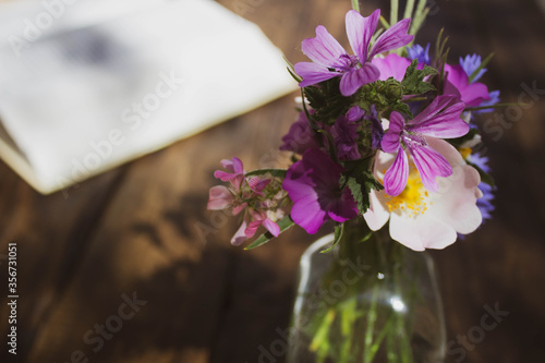 open book and vase on wooden table