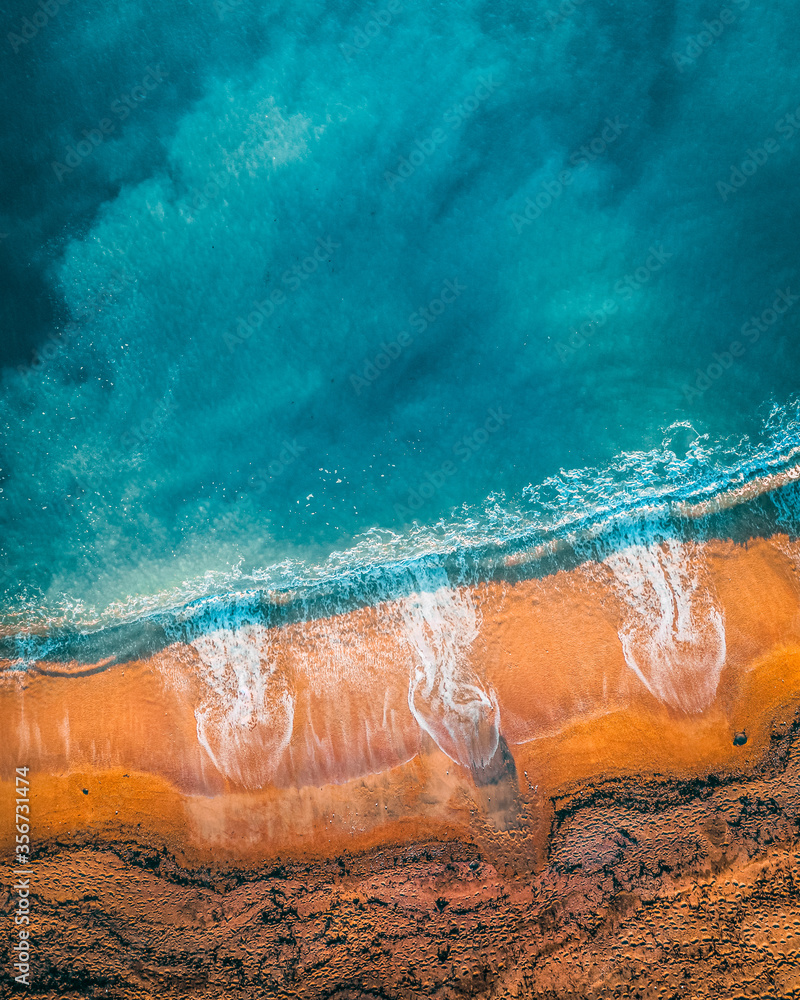 Aerial view of orange sand on the beach shore at Ringstead, Dorchester, UK Aerial view of orange sand on the beach shore at Ringstead, Dorchester, UK