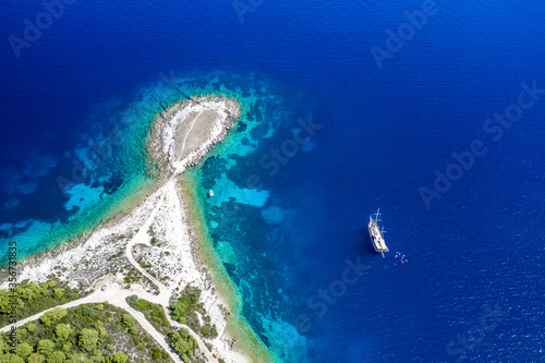 Aerial view of a boat in the turquoise waters of Plaza Komarca, Rogacic, Croatia photo