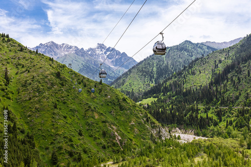 beautiful, bright, summer mountain landscape with a cable car. the concept of travel and recreation.