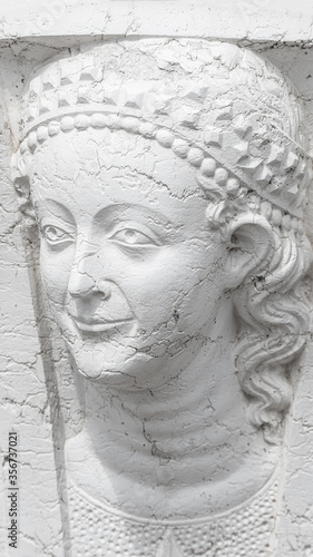 Portrait of ancient aged sculpture of beautiful Venetian Renaissance Era woman in Venice, Italy, closeup, details