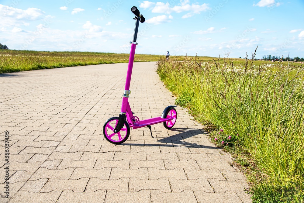 baby scooter for a girl on a bike path