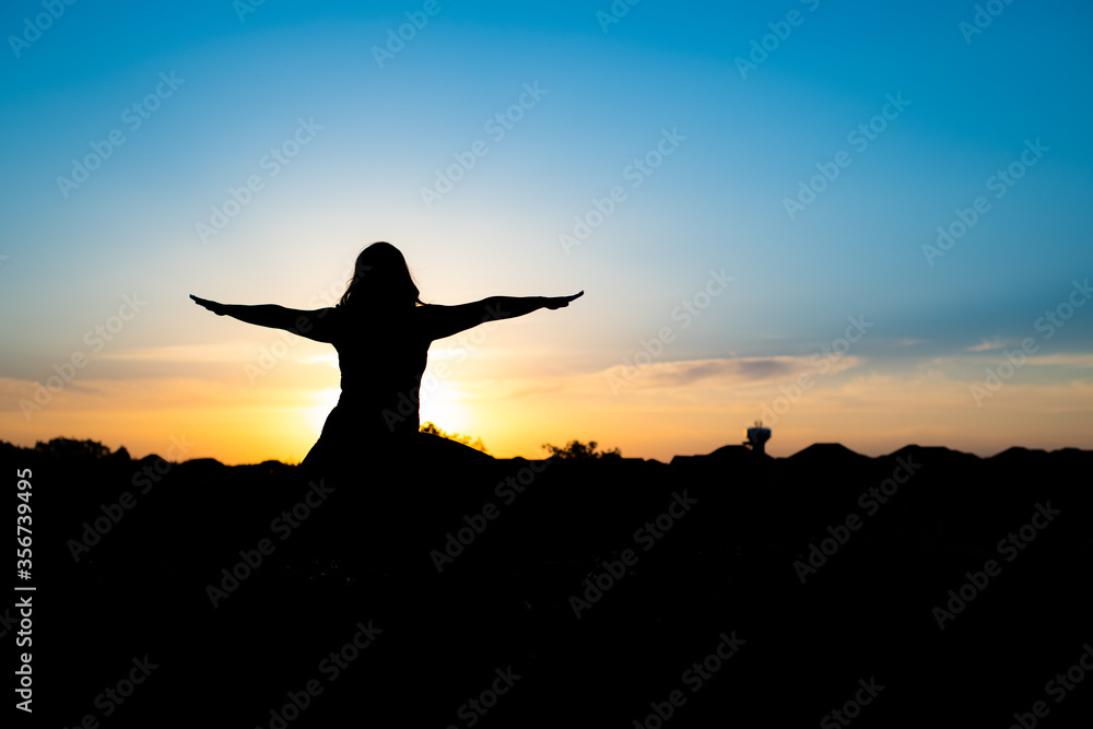 silhouette of woman doing yoga in the sunset silhouette of woman doing yoga in the sunset