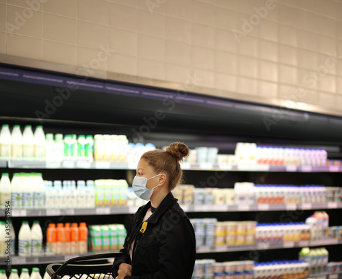supermarket shopping, face mask and gloves,Woman choosing a dairy products at supermarket 