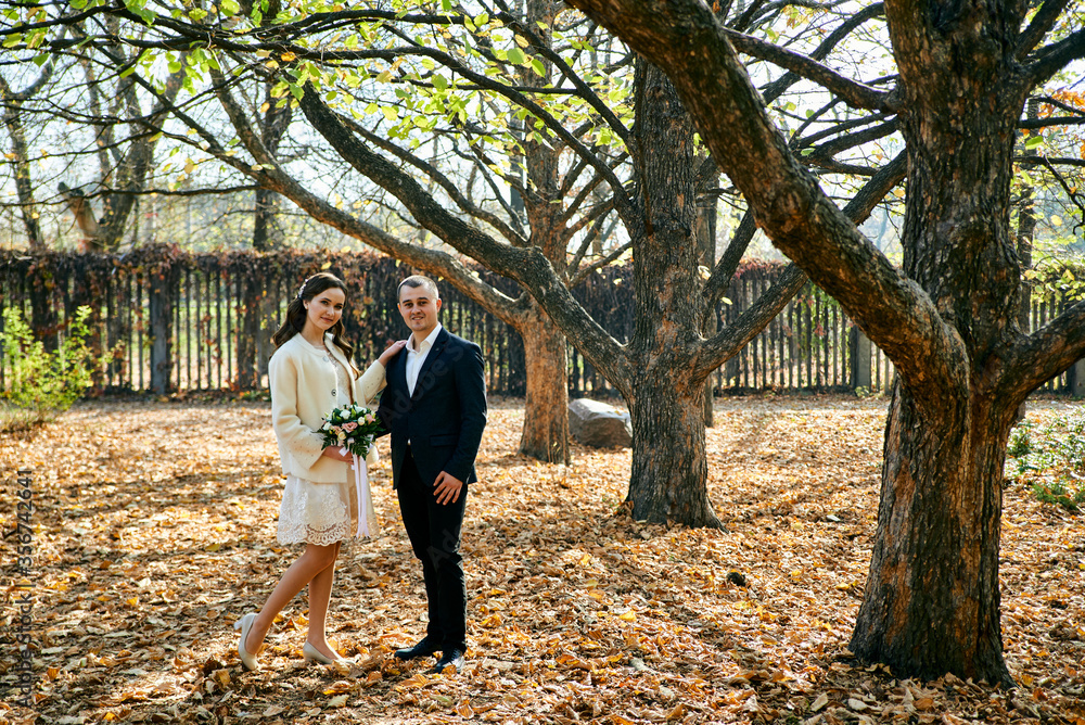 Fototapeta premium Young male and woman just married. Concept of happy family. Modern family outdoor.