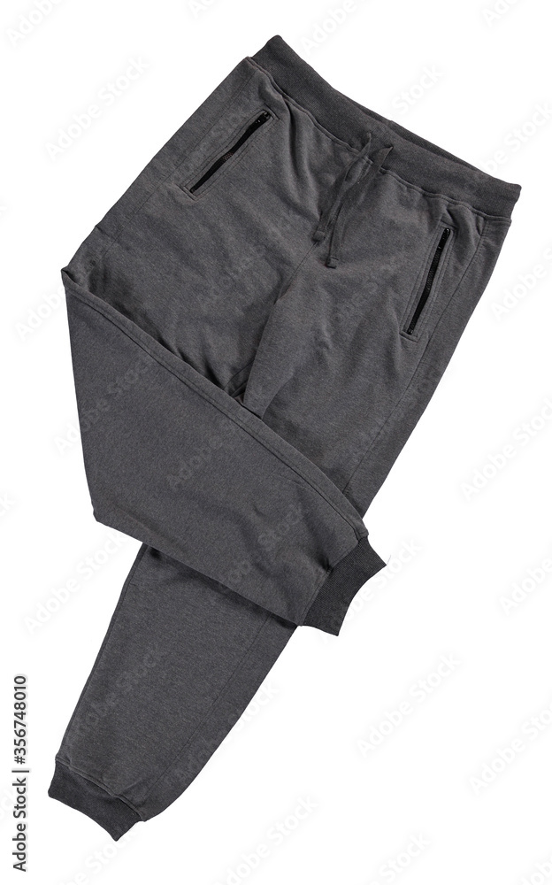 Folded gray jogging pants. Isolated image on a white background. Folded gray jogging pants. Isolated image on a white background.
