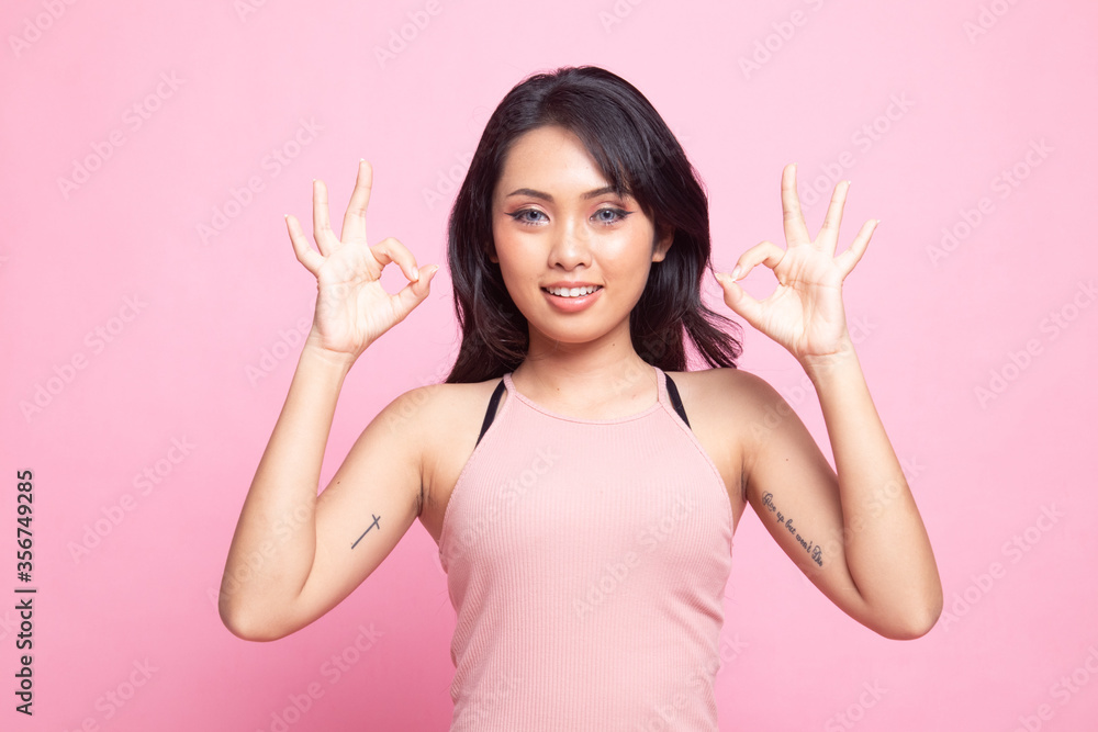 Asian woman show double OK hand sign and smile. Asian woman show double OK hand sign and smile.